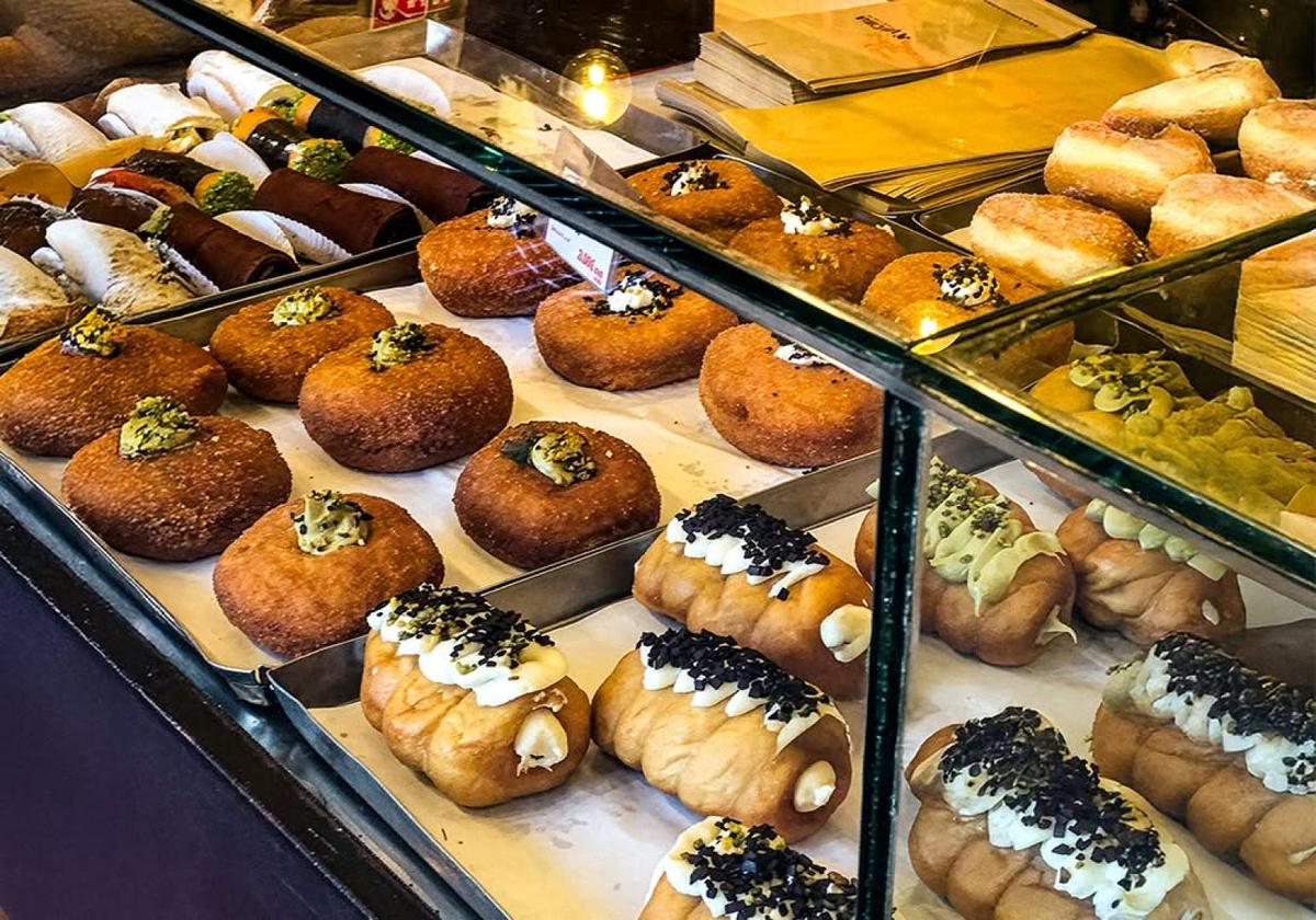 Pastry display filled with Italian desserts in a Milan bakery
