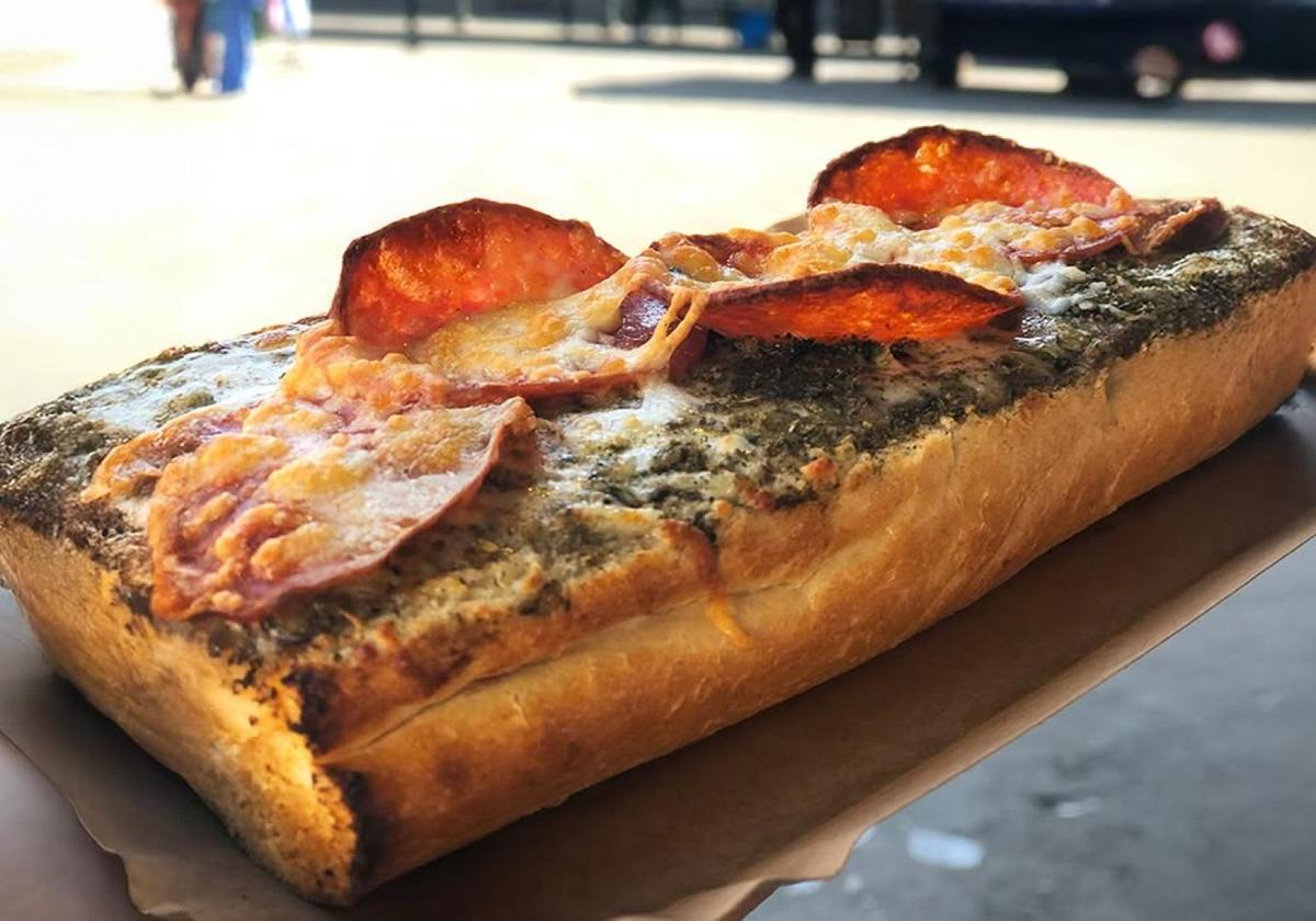 Freshly baked flatbread with melted cheese and toppings