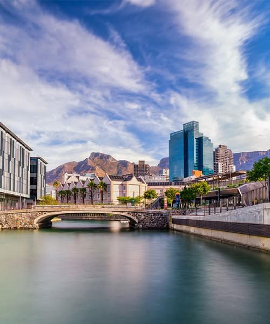 Modern canal and bridge at the V&A Waterfront with Table Mountain in the background.
