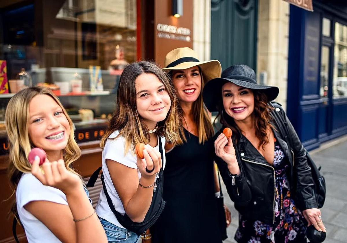 Group of smiling women posing together outside a restaurant on a food tour