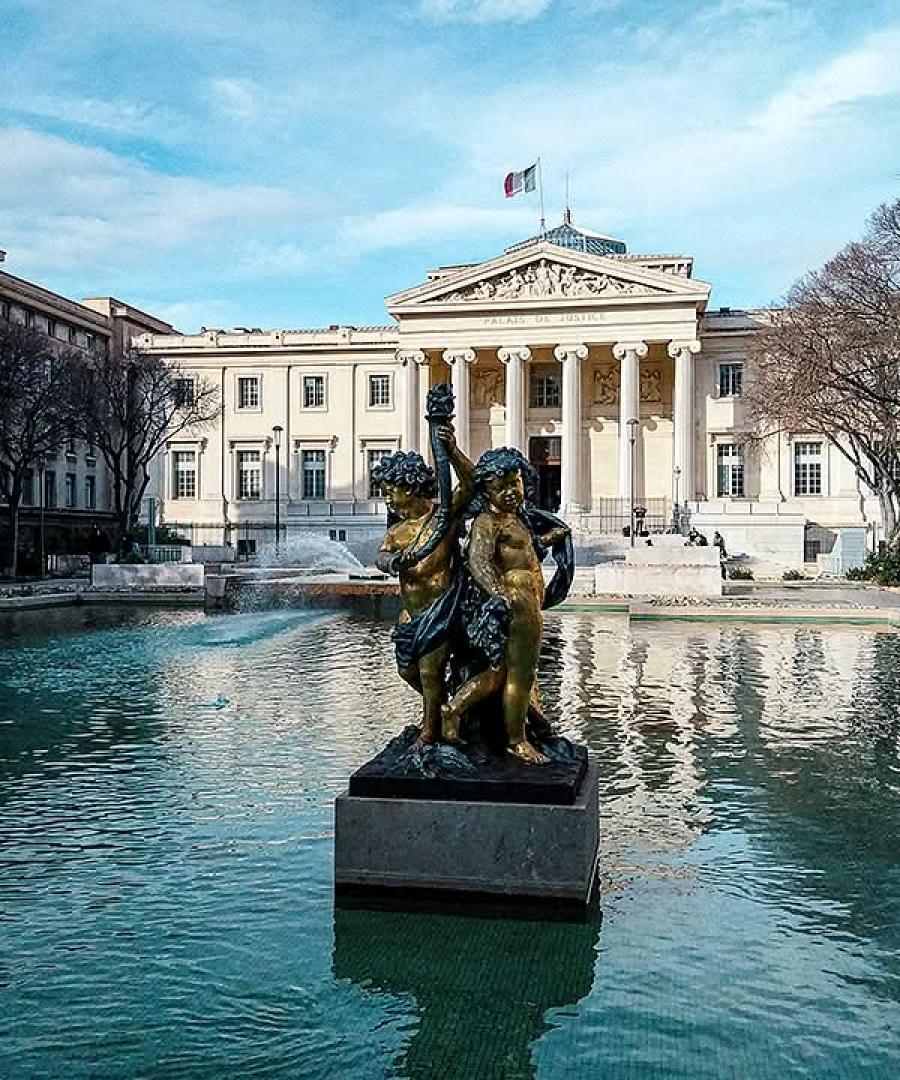 Palais de Justice in Marseille with fountain and statue in the foreground