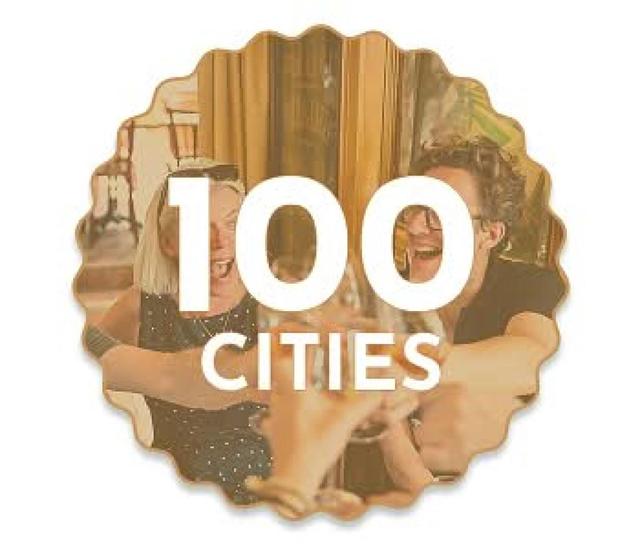 100 Cities badge over guests enjoying food and drinks at a Secret Food Tour