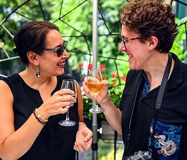 Couple sharing drinks and smiling on a private food tour