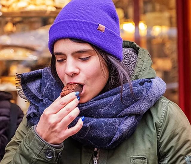Guest tasting chocolate pastry during a city food tour