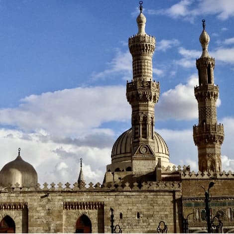 sun shining on the minarets of the al azhar mosque