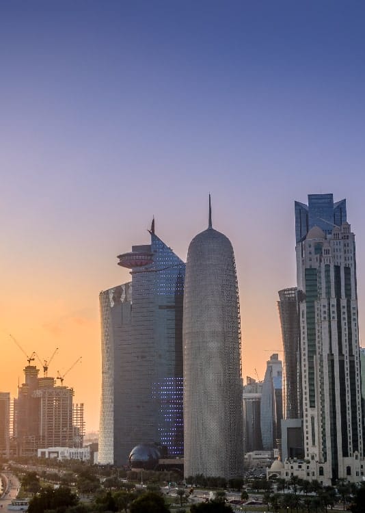 sunset over the skyscrapers of doha city in qatar