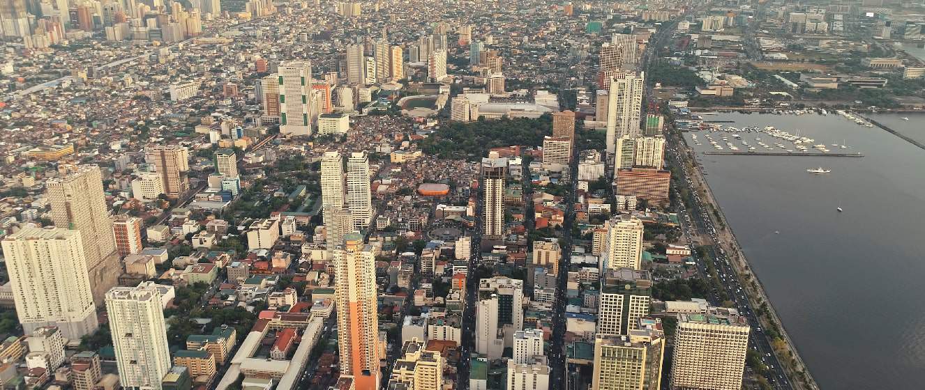 metropolis port city of manila at sea bay aerial
