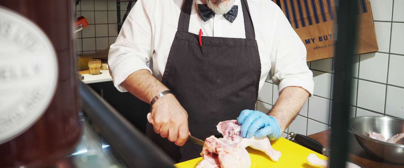 Butcher cutting chicken
