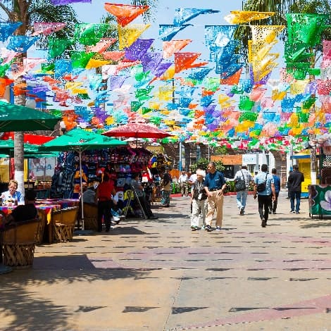 historic Mexican square with colorful hanging flags