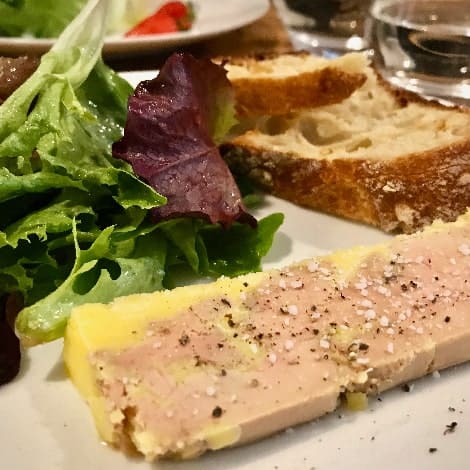 dinner plate of foie gras bread and salad